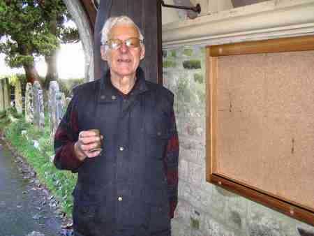 Arthur Herbert beside the new notice board he made for Belstone church