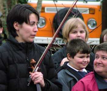 Teacher smiles at violinist