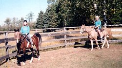 Two riders in outdoor ring